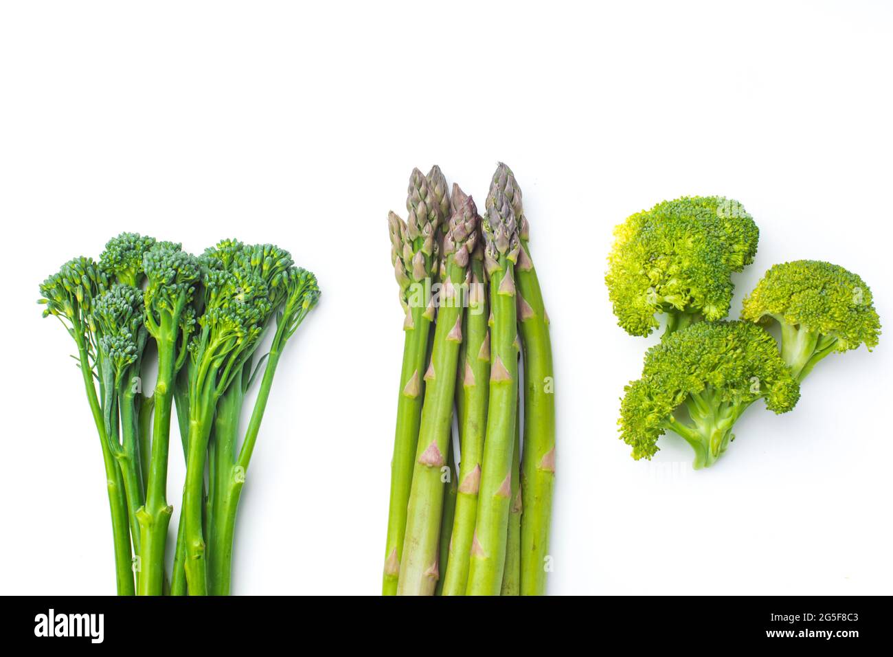Raw broccolini at the row on white background Stock Photo Alamy