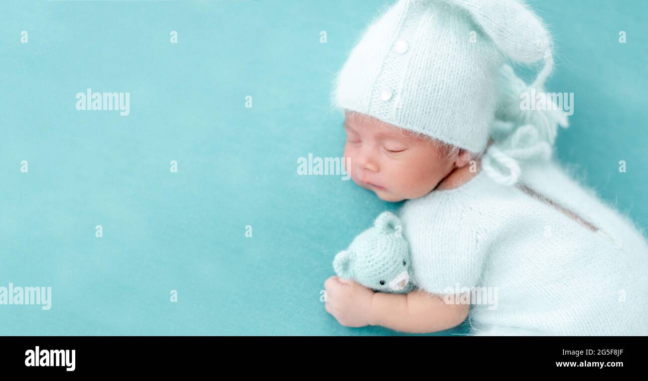 Cute newborn in knitted suit Stock Photo