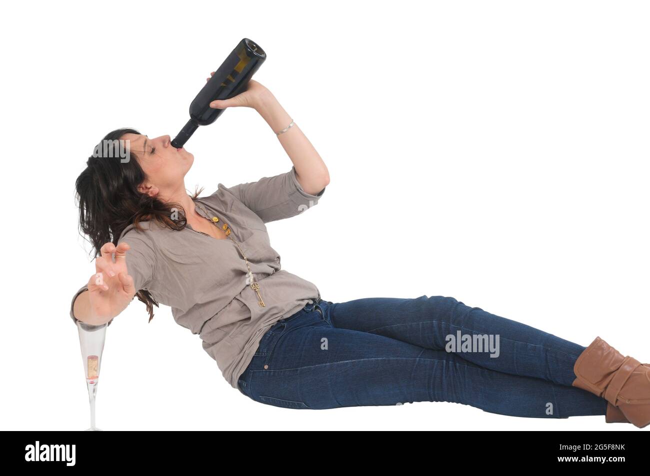 young woman prefers drinking her red wine straight out of the bottle for quicker and cleaner results studio shot on white background Stock Photo
