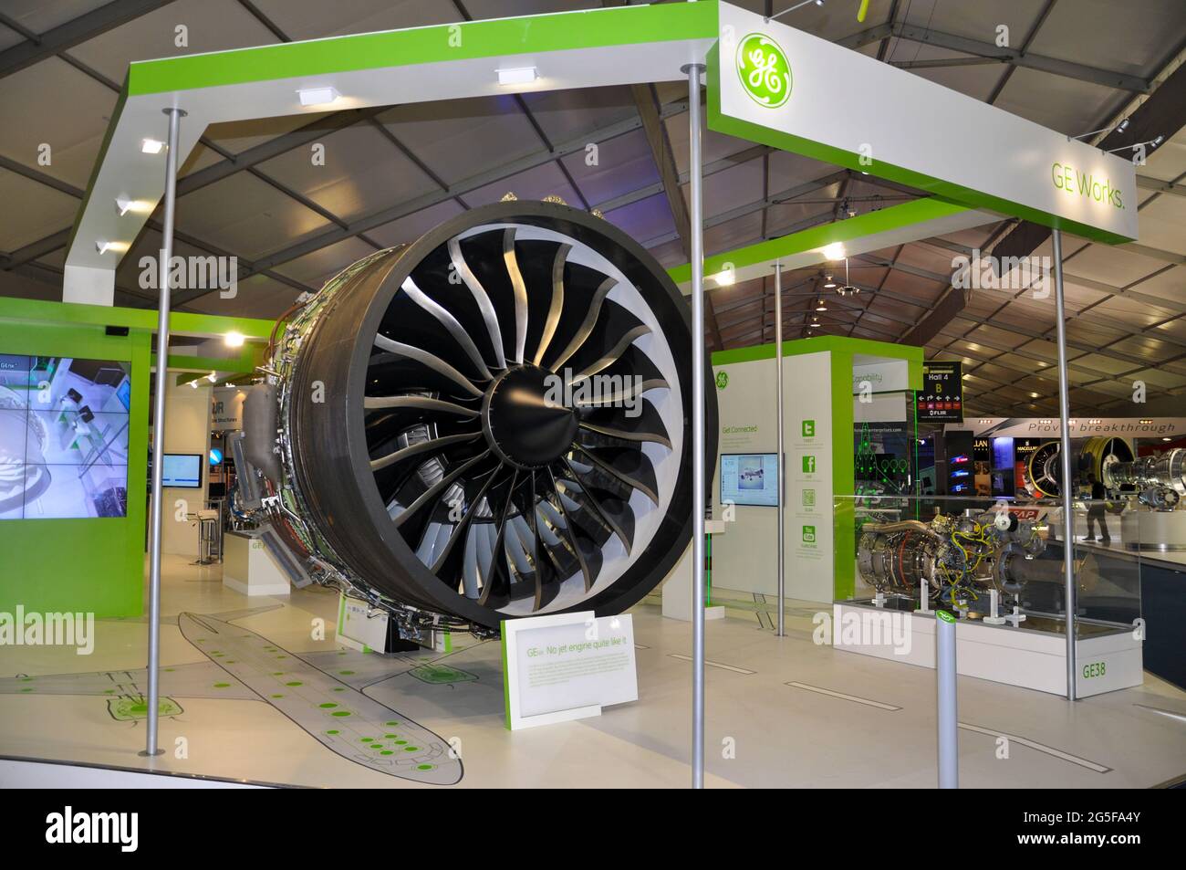 General Electric GEnx high-bypass turbofan engine display stand at the Farnborough International Airshow trade fair 2012, UK. Green scheme Stock Photo