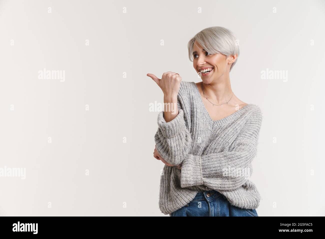 Happy beautiful silver girl smiling and pointing finger aside isolated ...