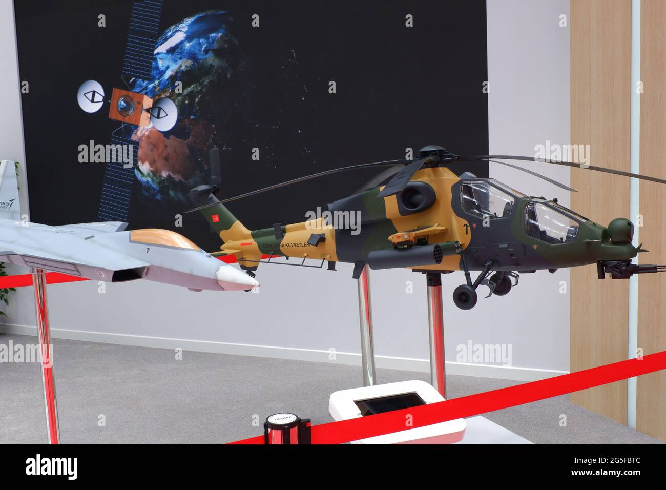 Models of Turkish designed aircraft and attack helicopter at industrial fair indoor Stock Photo