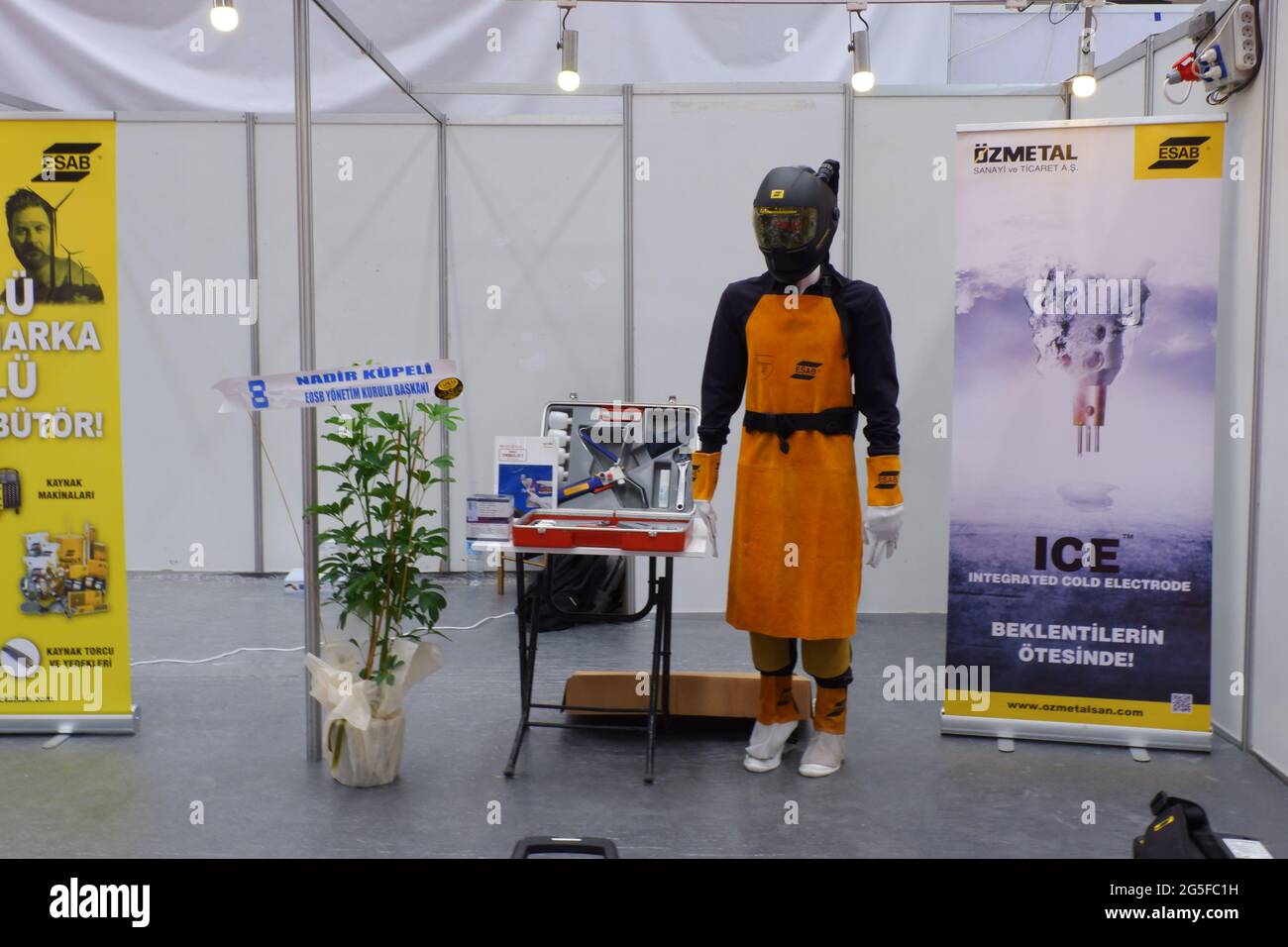 Model dressed with welding protective equipment at exhibition in an industrial fair Stock Photo