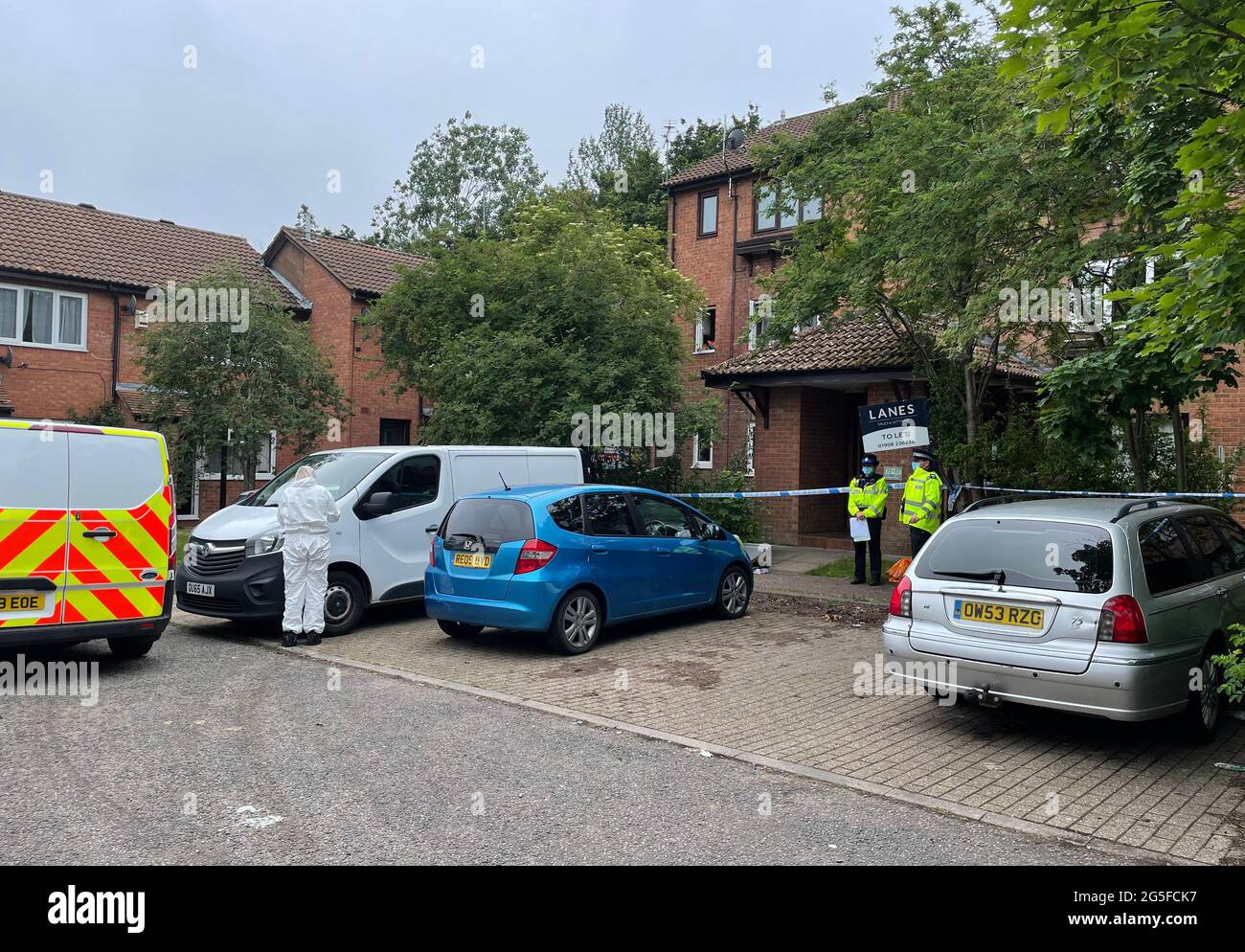 Police at the scene in Denmead, Two Mile Ash, in Milton Keynes, where a man has died after police fired gun shots at a property and where a second man was found dead and a young child seriously injured. Thames Valley Police (TVP) said in a statement officers were called to an address in Denmead, Two Mile Ash, at about 9.40am on Saturday and made a forced entry after acting on information from a witness. Picture date: Sunday June 27, 2021. Stock Photo