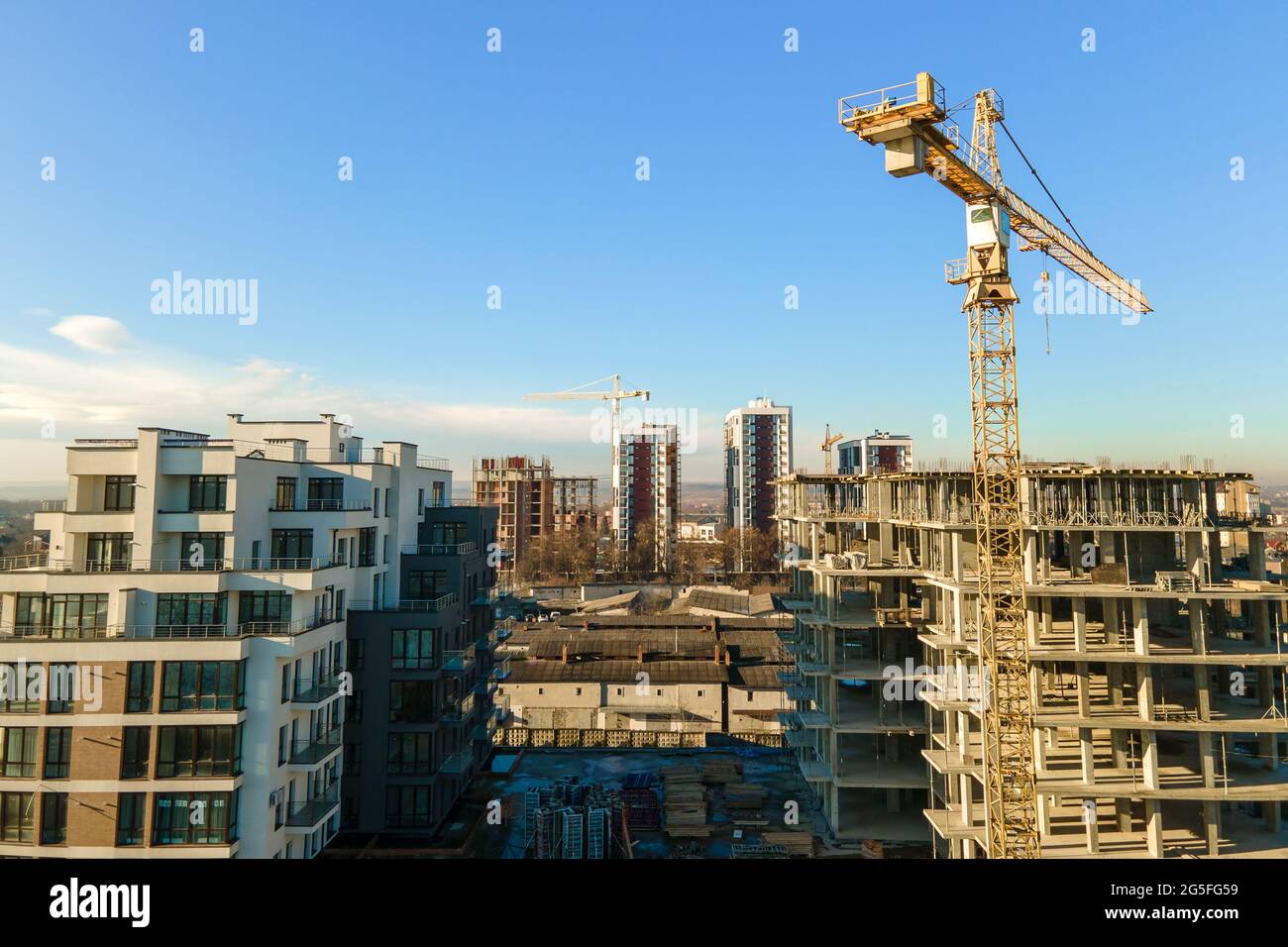 Aerial view of high tower crane and residential apartment buildings ...