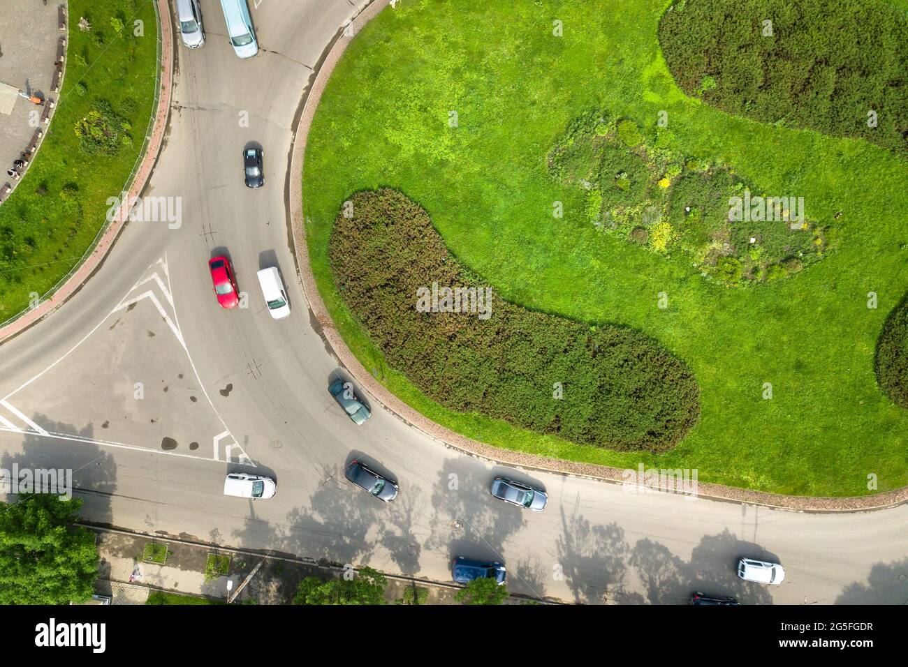 Top down aerial view of busy street roundabout intersection with moving ...