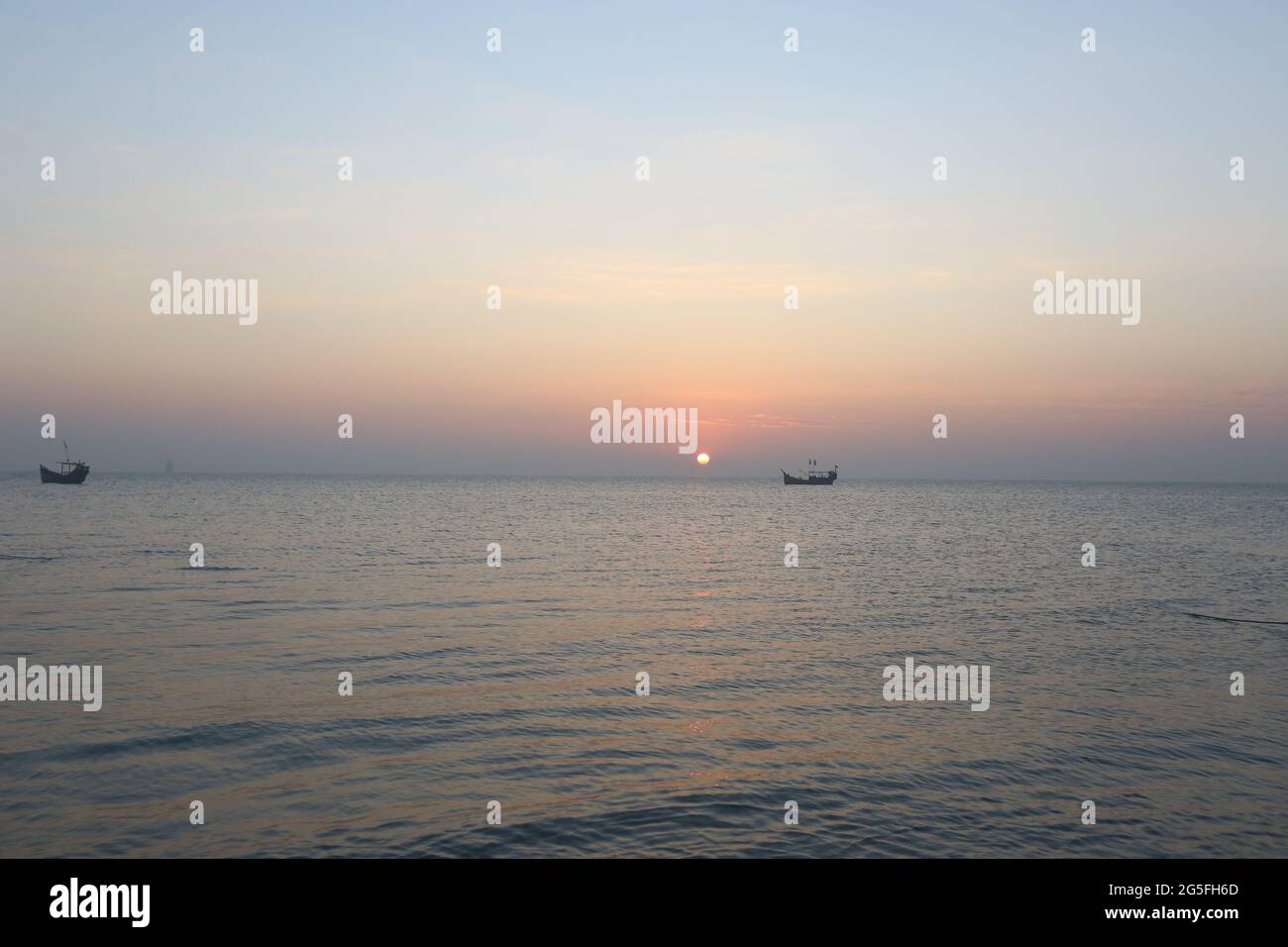 Beautiful views of the sunset at dusk.The sun is slowly sinking into the sea. Stock Photo