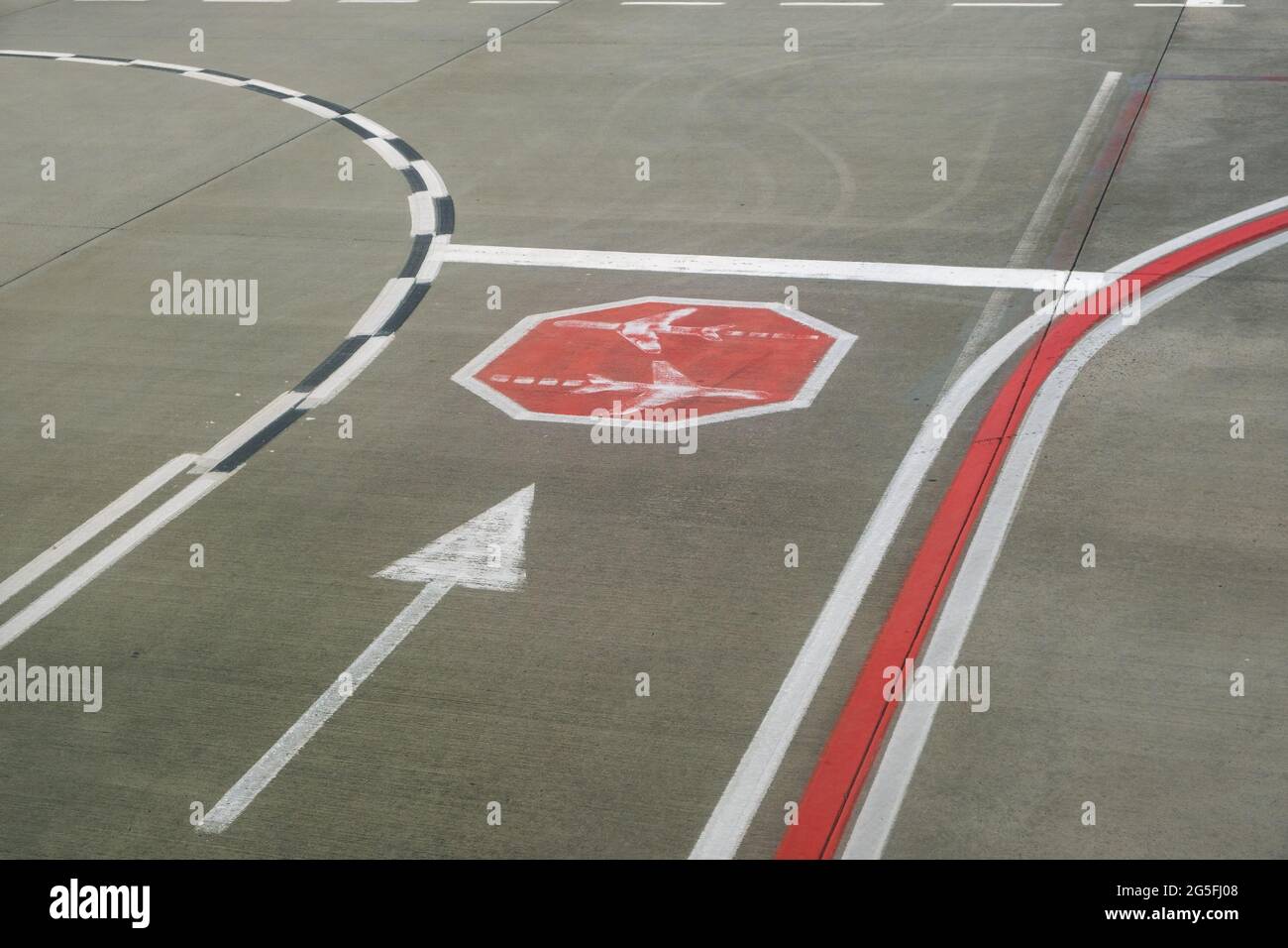 Road sign markings on runway surface for airplane taxiing traffic Stock
