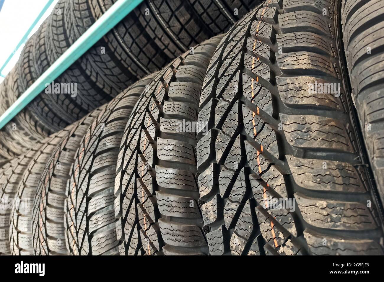 Many black rubber car tires on store shelf for sale Stock Photo Alamy