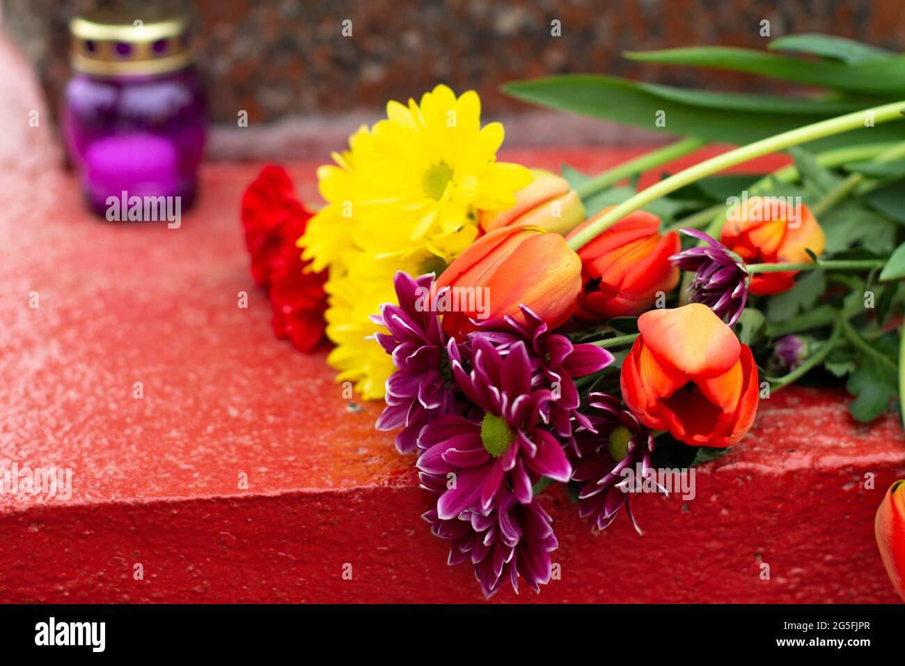 Flowers on the grave. Flowers on a military monument. Flowers with a