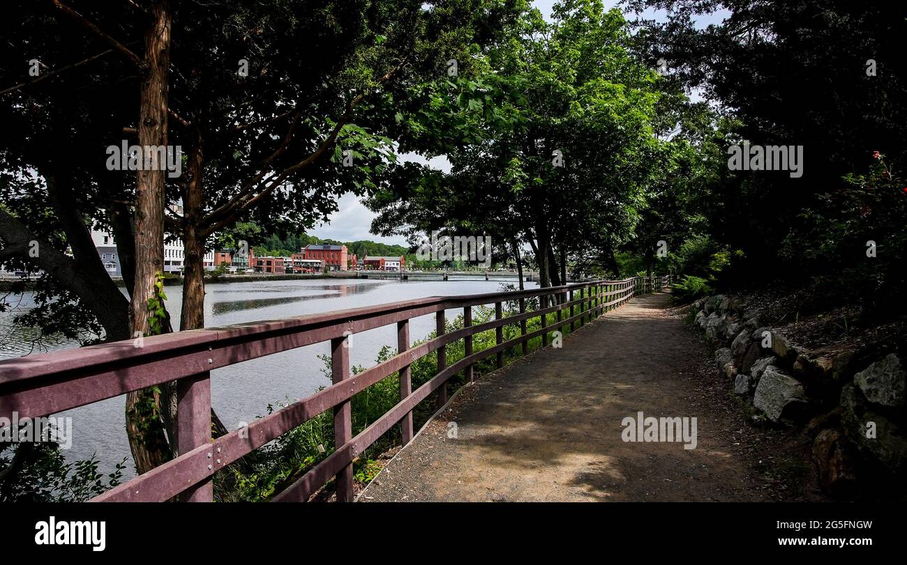 WESTPORT, CT, USA - JUNE 26, 2021: View from walkway near Saugatuck river waterfront with bridge and building in distance Stock Photo