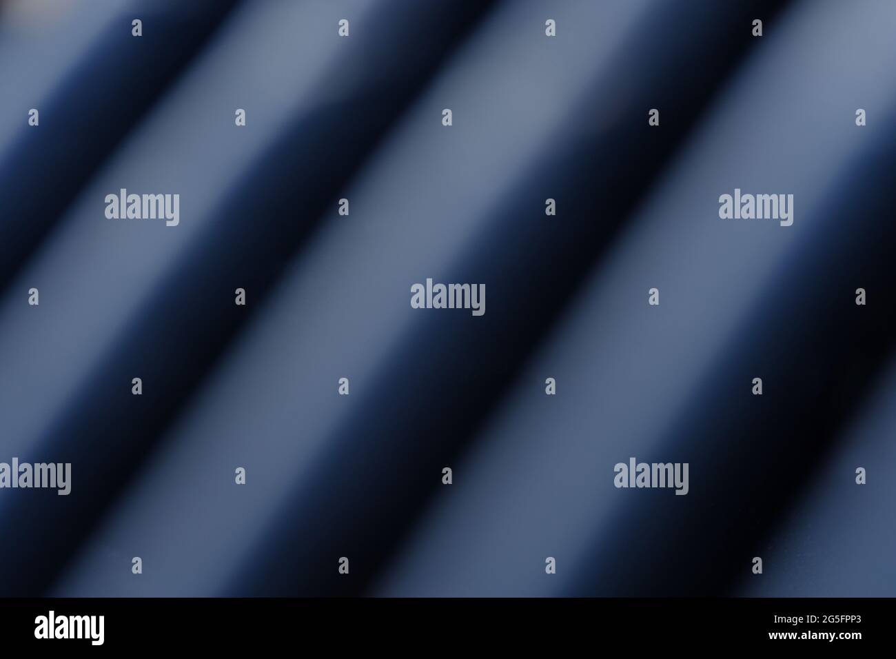 Abstract macro photography. Soft blurred metal texture, line pattern background with blue light Stock Photo