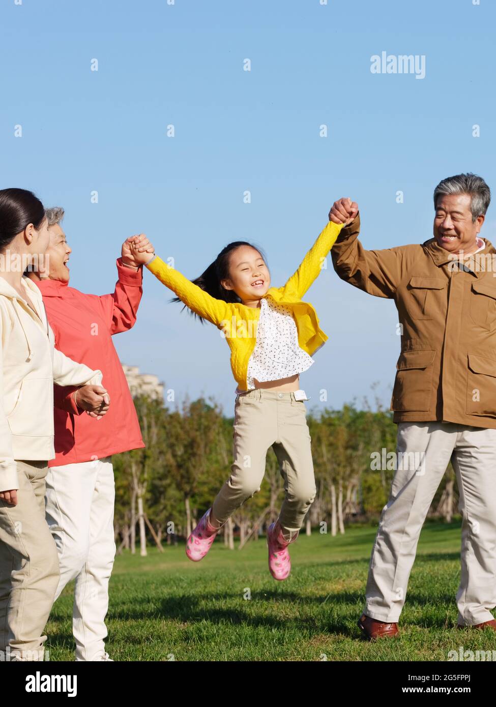 Happy family of four playing in the park high quality photo Stock Photo