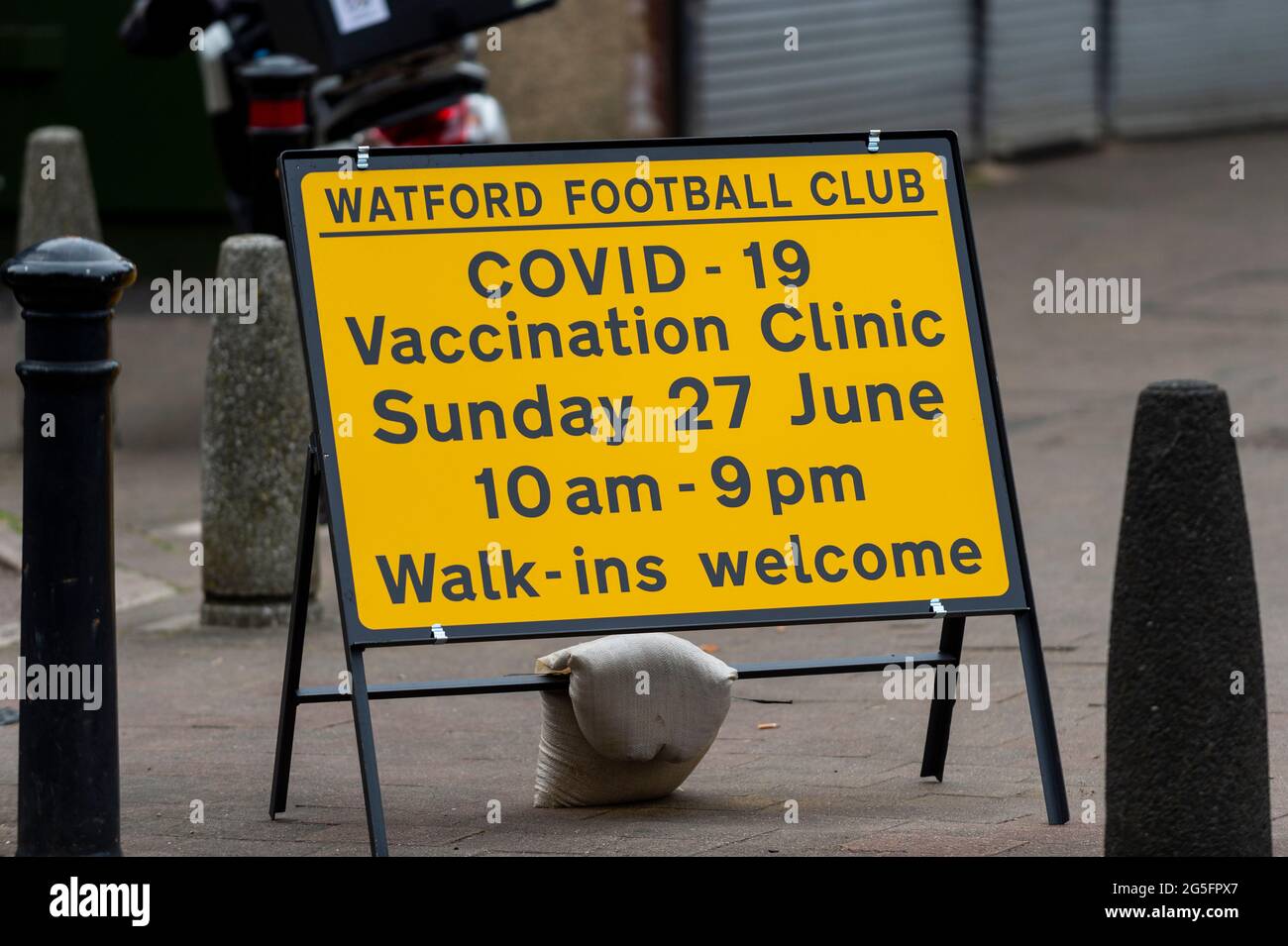 Watford, UK.  27 June 2021.  A sign outside a pop-up mass vaccination clinic at Watford FC’s Vicarage Road Stadium as part of the “Grab a jab” campaign. The NHS is also promoting a number of walk-in clinics this weekend across the capital to try to increase the number of over 18s receiving a jab as cases of the Delta variant are reported to be on the rise.  Credit: Stephen Chung / Alamy Live News Stock Photo