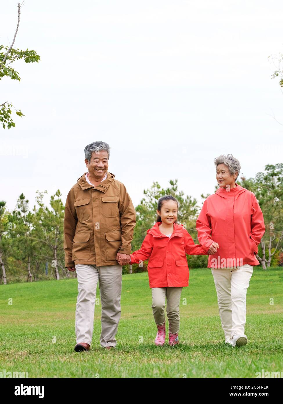 Happy grandparents and grandchildren walking in the park high quality photo Stock Photo