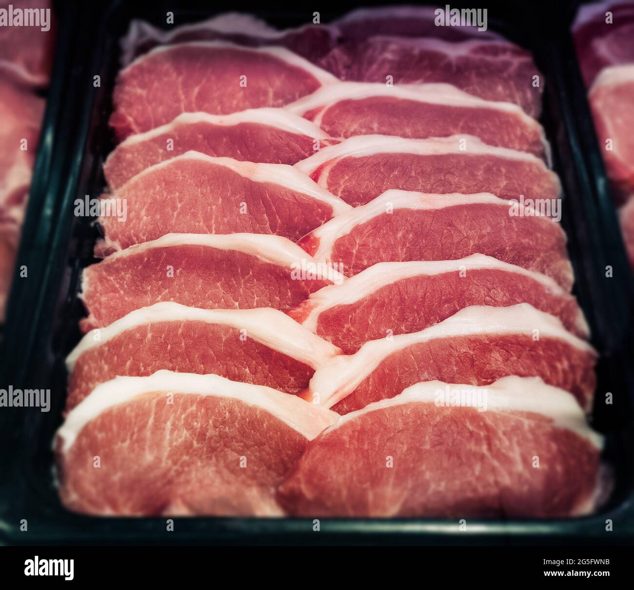 sliced pork meat in containers at market Stock Photo Alamy