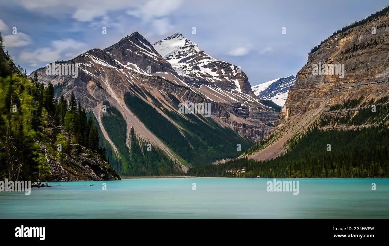 The silky looking turquoise water of Kinney Lake in Robson Provincial Park in the Canadian Rockies in British Columbia, Canada. Whitehorn Mountain and Stock Photo