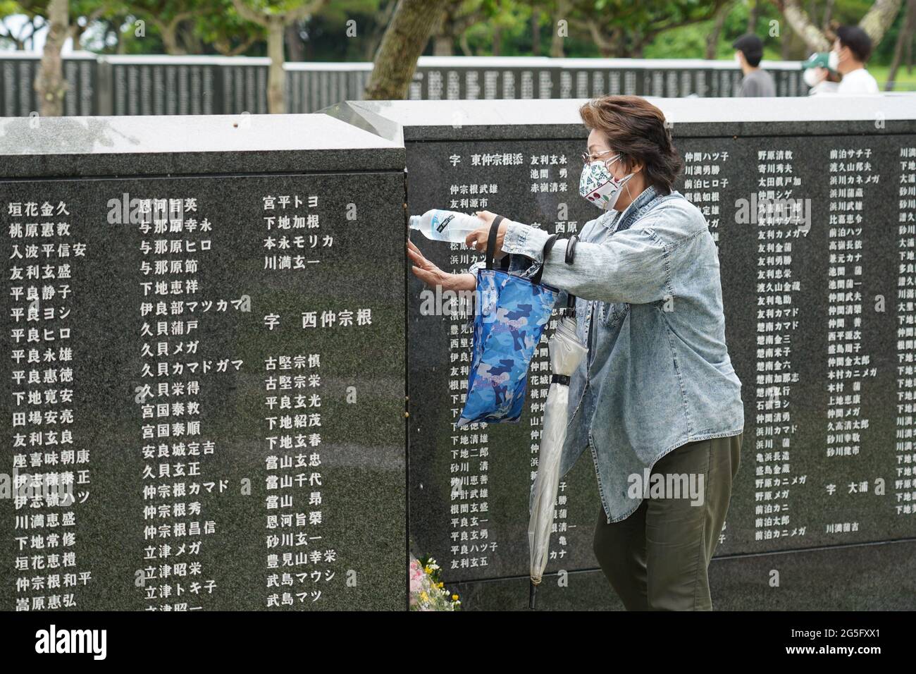 A Woman Pours Water Over The Monument Cornerstone Of Peace Remembering Her Family And Victims Of The Battle Of Okinawa Okinawa Marks The 76th Anniversary Of The End Of A Major World War