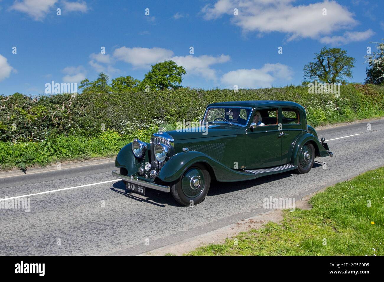 1936 30s thirties green Bentley 4257cc 4dr sedan petrol saloon en-route to Capesthorne Hall classic May car show, Cheshire, UK Stock Photo
