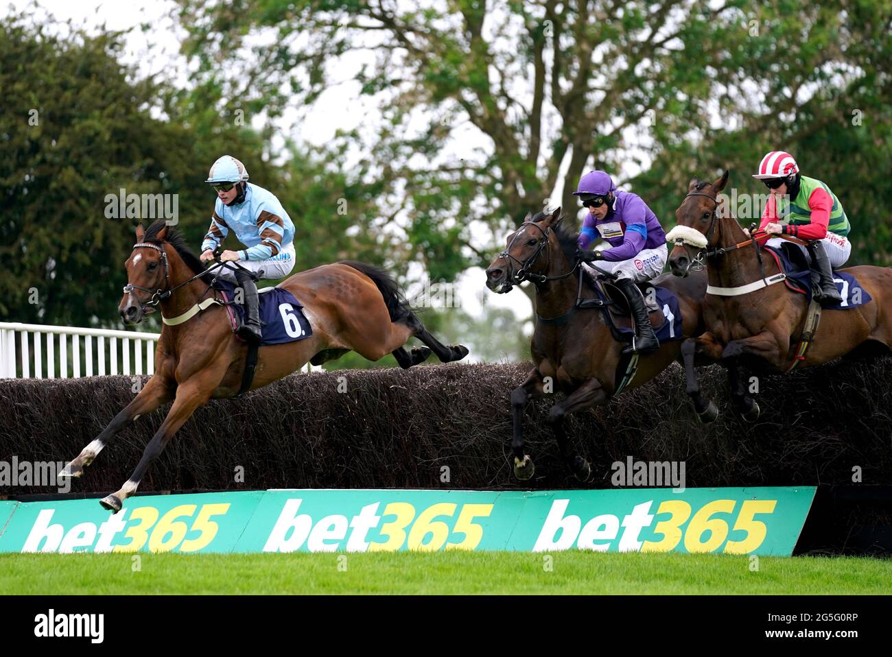 Statuario ridden by James Bowen (left) clears a hurdle whilst competing in the bet365 Handicap Chase at Uttoxeter Racecourse. Sunday June 27, 2021. Stock Photo