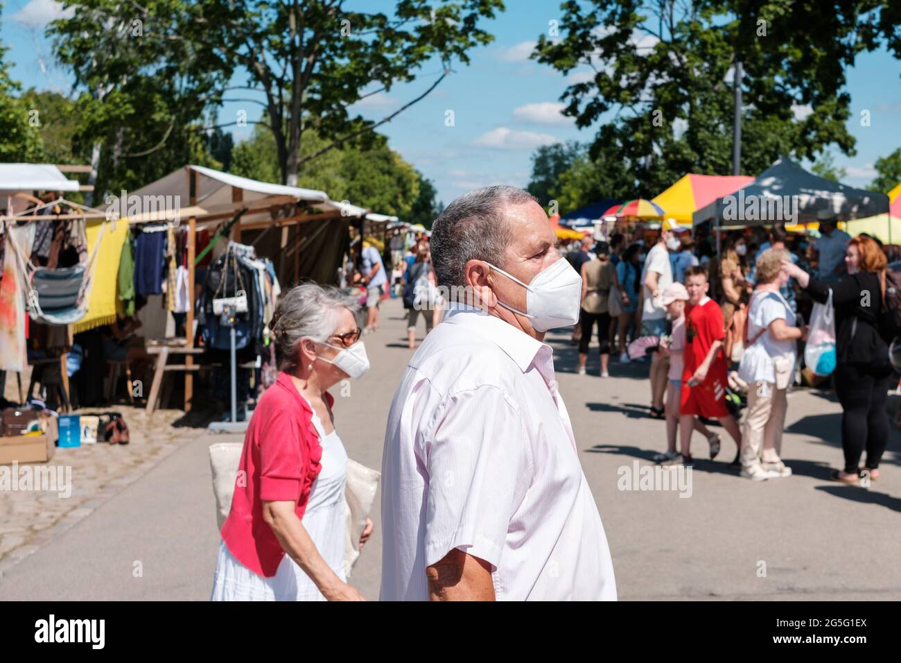Berlin, Germany June, 2021 Elderly Couple wearing face mask, outdoor