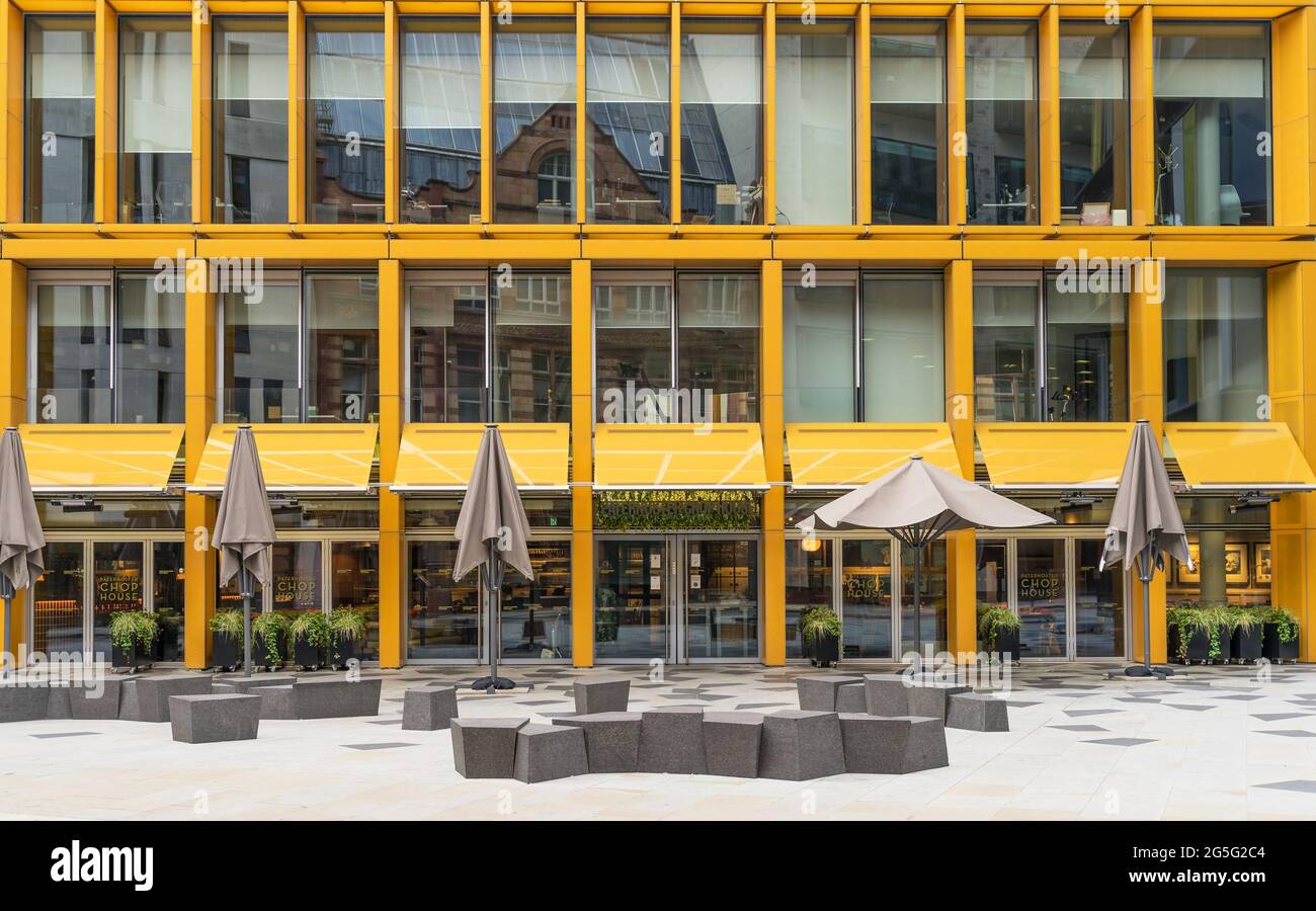 The bright yellow facade and outside seating of the Paternoster Chop House Restaurant down the Old Bailey Road. London - 27th June 2021 Stock Photo