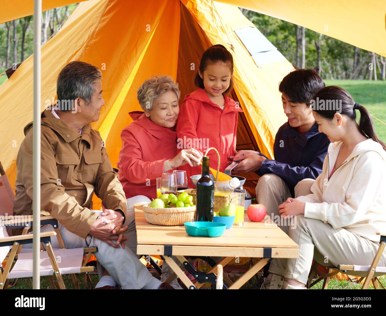 A happy family of five having a picnic outdoors high quality photo Stock Photo