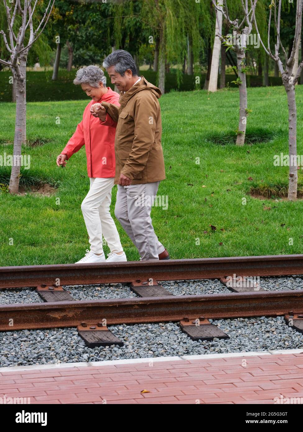 Chinese couple park man woman walk two hi-res stock photography and ...
