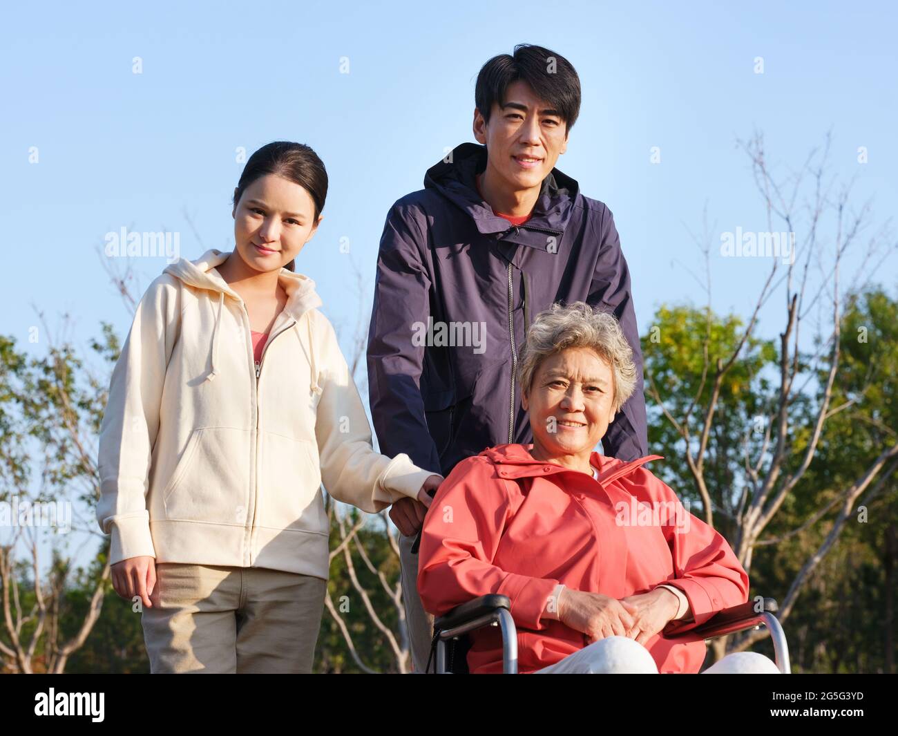 A happy family of three walking in the park high quality photo Stock Photo