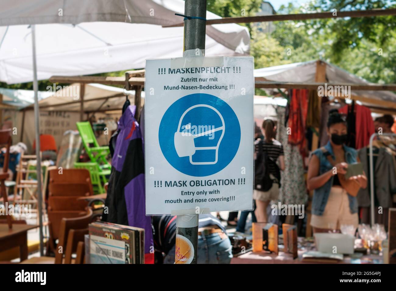 Berlin, Germany - June, 2021: Mask mandatory sign at flea market in Berlin Stock Photo