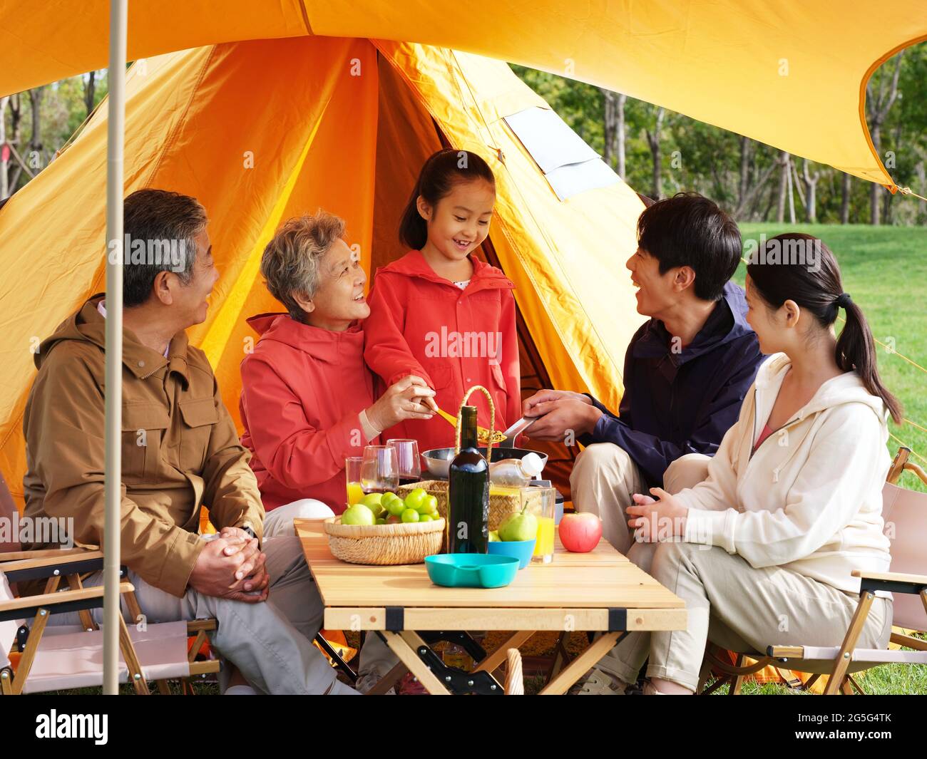 A happy family of five having a picnic outdoors high quality photo Stock Photo