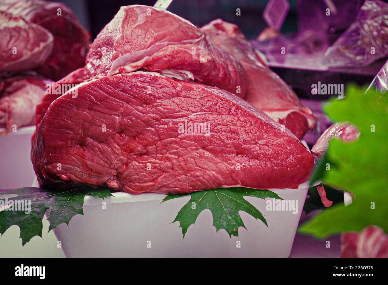 Fresh raw meat isolated over the butcher's counter Stock Photo