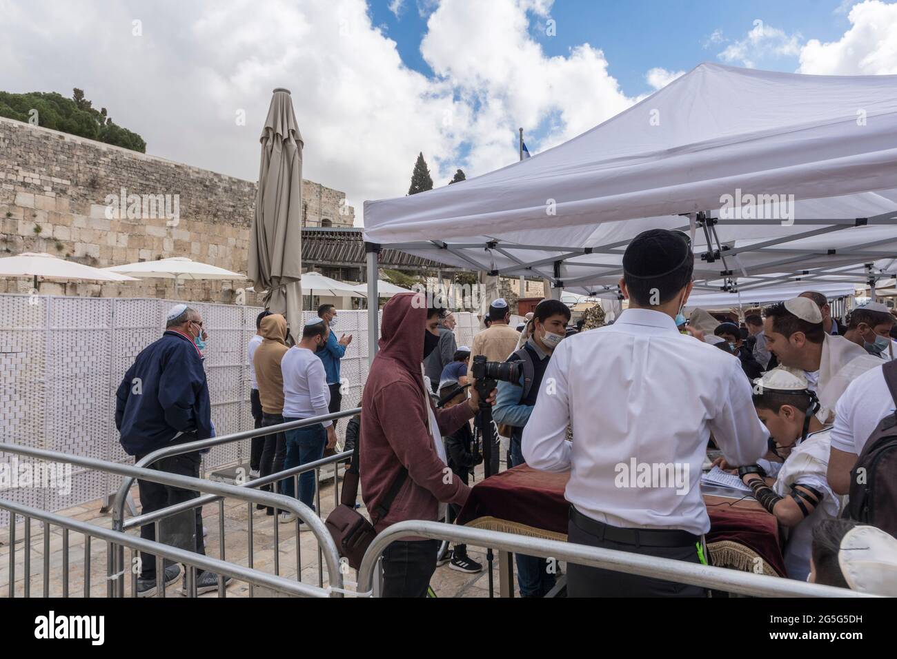 Jerusalem, Israel. A bar Mitzvah ceremony at the Western Wall, one of the holliest places for Judaism, during the COVID pandemic. The area was equipped with barriers and dividers to seperate people praying and keep a measure of social distancing. Stock Photo