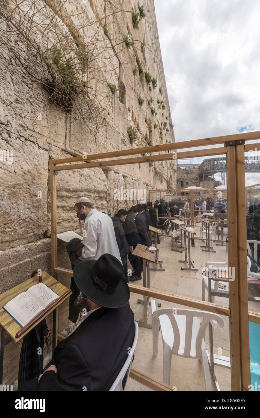 Jerusalem, Israel. The Western Wall, one of the holliest places for Judaism, also known as the 'Wailling wall', was equipped with barriers and dividers to seperate people praying during the Covid-19 pandemic. Stock Photo