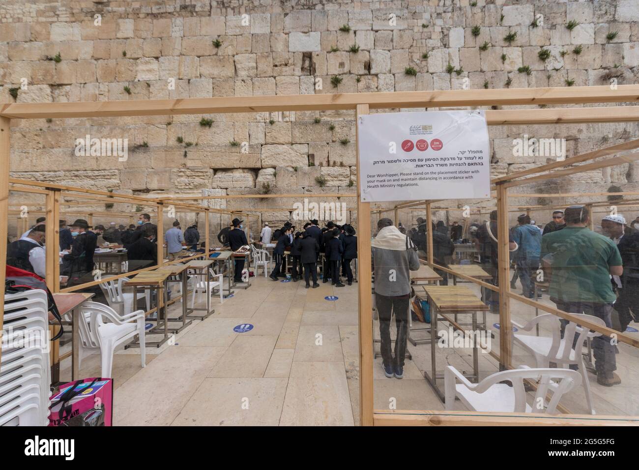 Jerusalem, Israel. The Western Wall, one of the holliest places for Judaism, also known as the 'Wailling wall', was equipped with barriers and dividers to seperate people praying during the Covid-19 pandemic. Stock Photo