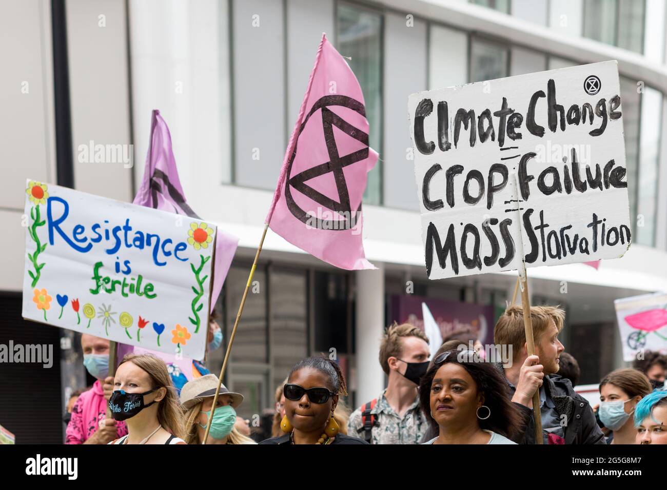 Extinction rebellion protestors hold up placards calling for greater  attention to be given to climate change issues.Extinction Rebellion  activists gathered at Parliament Square in an attempt to half mass  extinction and minimize