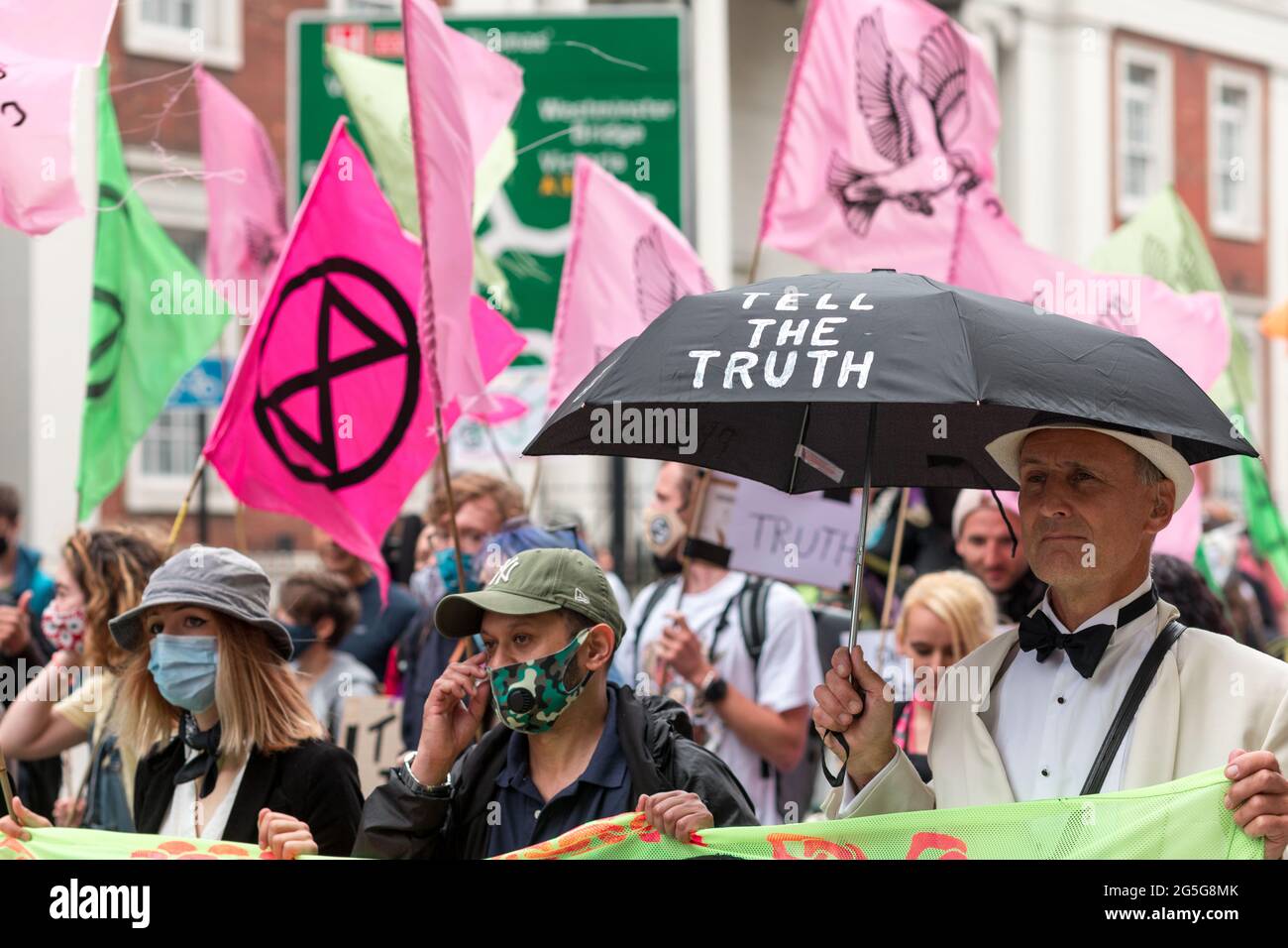 Extinction rebellion protestor holds an umbrella written on Tell the Truth during the demonstration.Extinction Rebellion activists gathered at Parliament Square in an attempt to half mass extinction and minimize the risk of social collapse. Specifically, this protest aims to increase the awareness of the UK population of media silencing, and the manipulation of information by the four billionaires that control the major UK newspapers. (Photo by Belinda Jiao / SOPA Images/Sipa USA) Stock Photo
