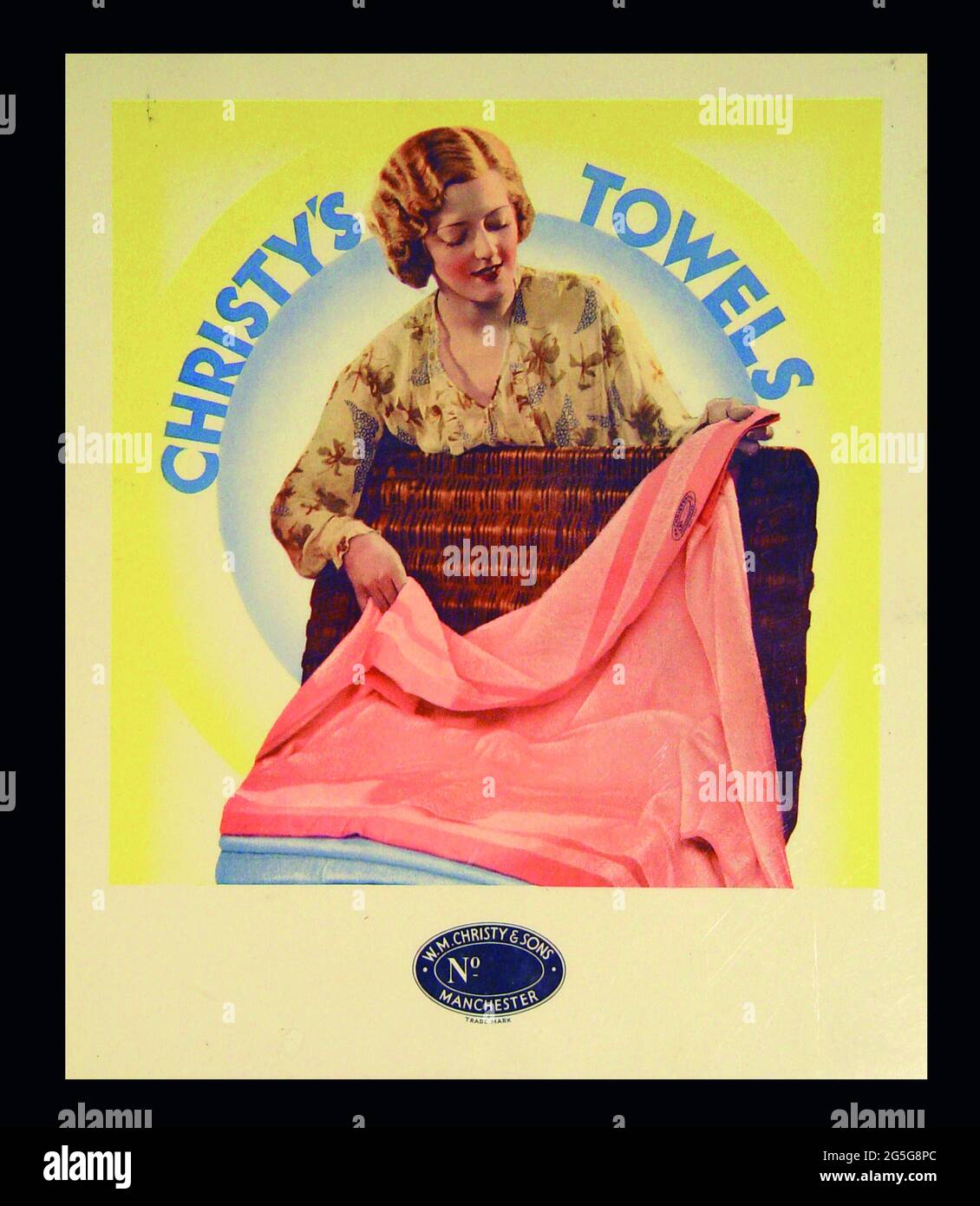Christy Towels. Drapery store. Display card advert. 1930s. Thirties. Art deco design. Advertising. Pretty girl with Thirties permanent wave, wicker basket, pink towel. Manchester Stock Photo