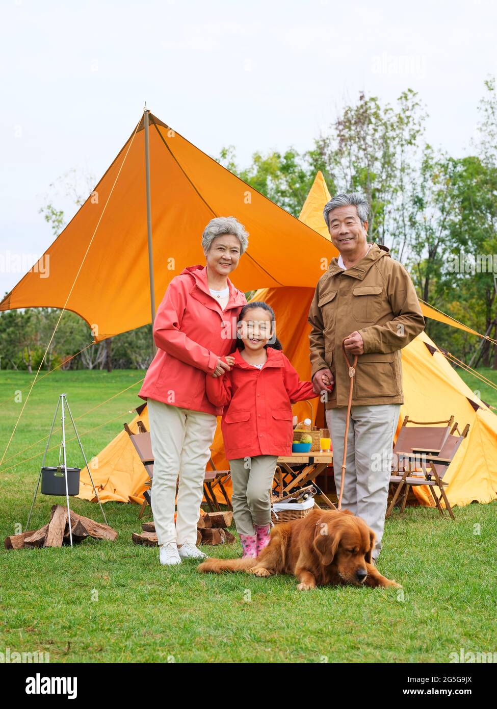 Happy grandparents and grandchildren take a group photo with their pet dog outdoors high quality photo Stock Photo