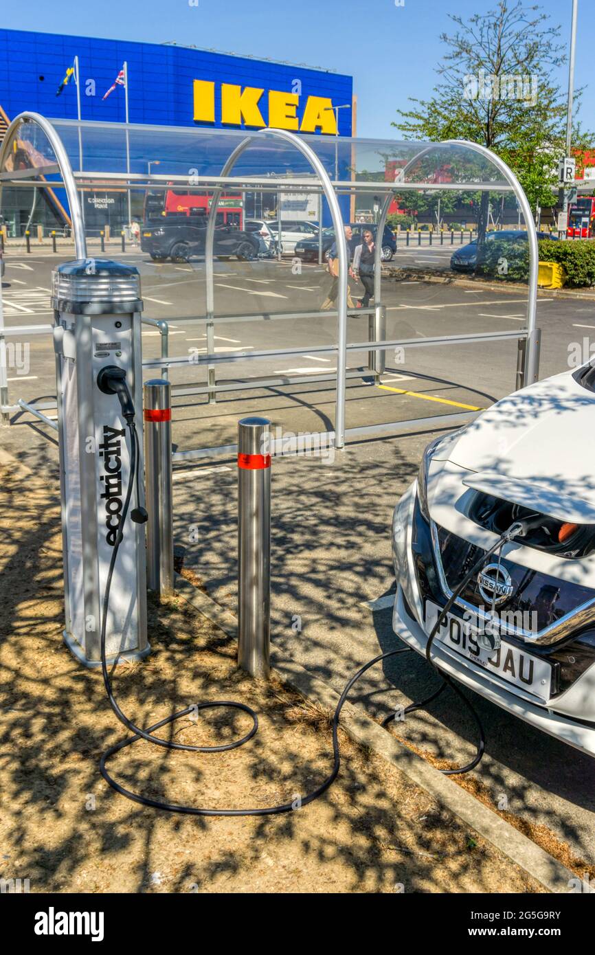 A Nissan LEAF electric car charging at an ecotricity charging point outside IKEA on the Greenwich Peninsula. Stock Photo