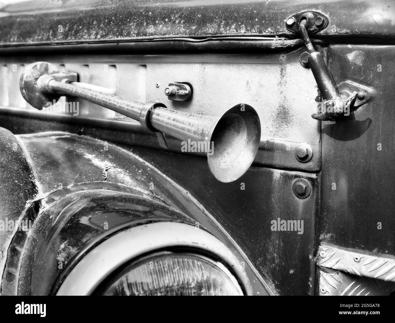 Fragment of a retro car with a signaling beep outside. Black and white
