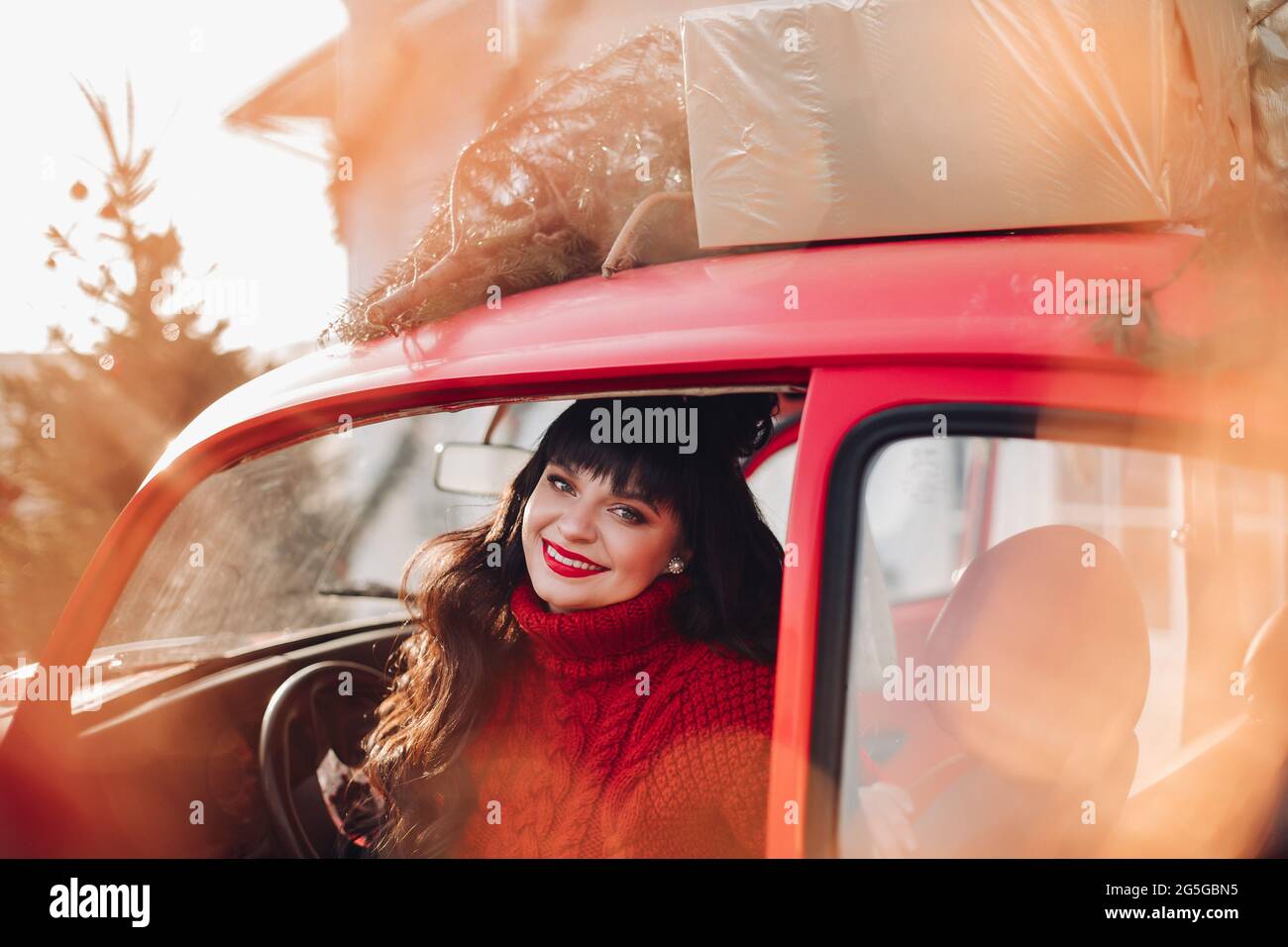 Beautiful woman in red vintage car Stock Photo - Alamy