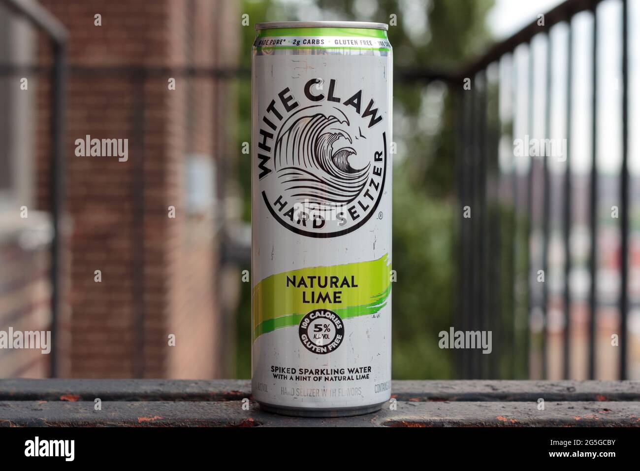 can of White Claw brand hard seltzer, spiked sparkling water, lime flavored, 5 percent alcohol, on a fire escape Stock Photo