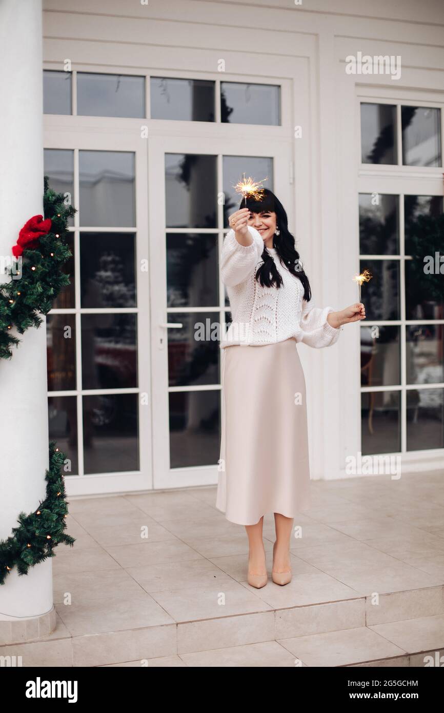 Attractive dark-haired woman with sparklers. Stock Photo
