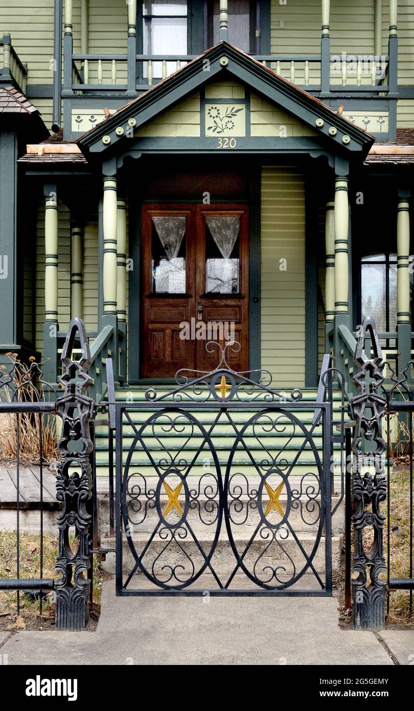 Ironwork gate and fence, along with the front of 1884 restored Victorian-era North Dakota Governors' Mansion (1893-1960) in  Bismarck, North Dakota . Stock Photo