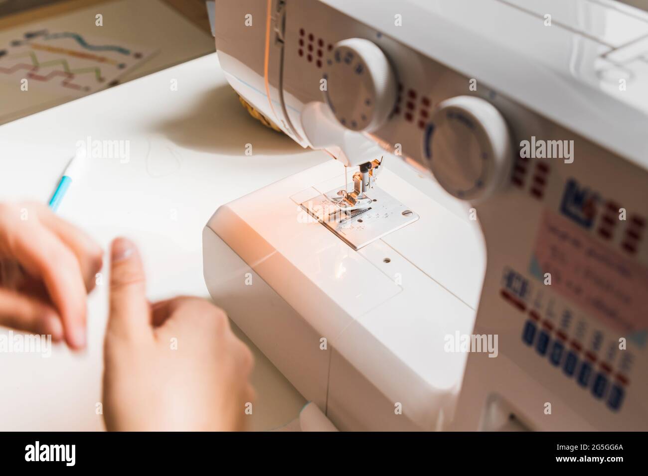 A woman hands using sewing machine Stock Photo Alamy