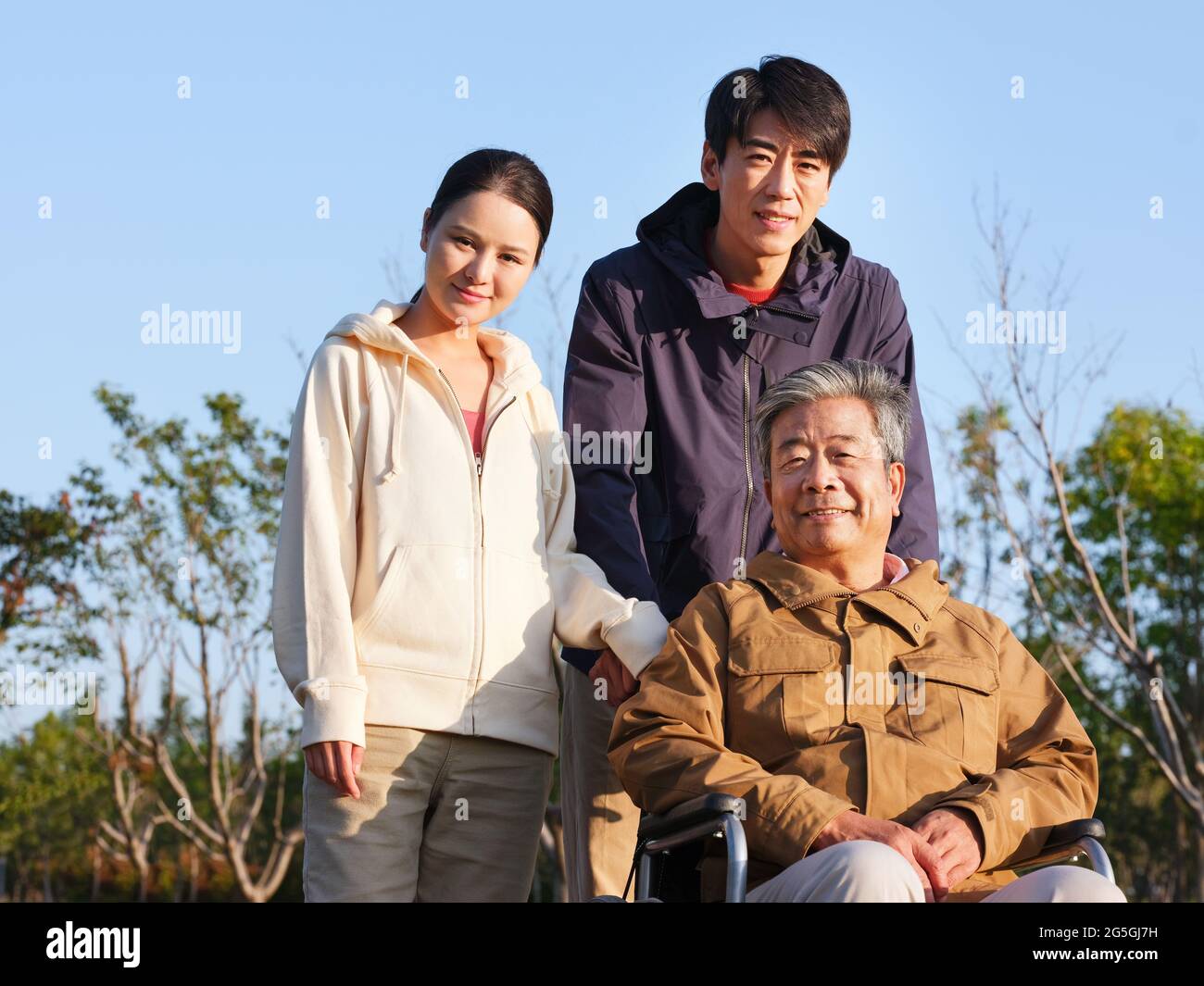 A happy family of three walking in the park high quality photo Stock Photo