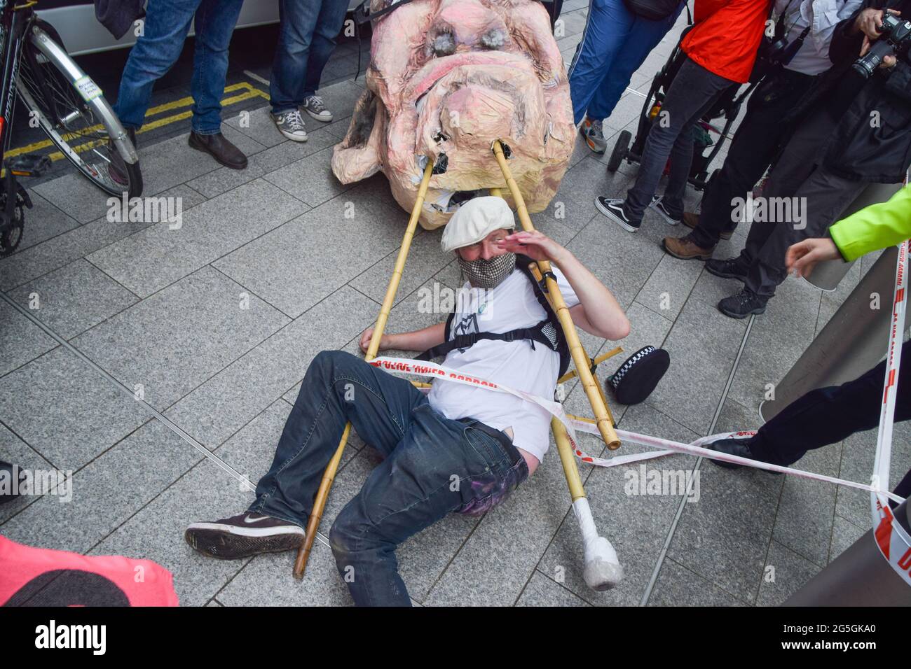 London, United Kingdom. 27th June 2021. A demonstrator falls after an incident with a police officer outside News UK during the Free The Press protest. Extinction Rebellion demonstrators marched from Parliament Square to News UK headquarters, owned by Rupert Murdoch, in London Bridge, in protest of misinformation, corruption, and the inaccurate and insufficient coverage of the climate crisis by Murdoch's newspapers. (Credit: Vuk Valcic / Alamy Live News) Stock Photo