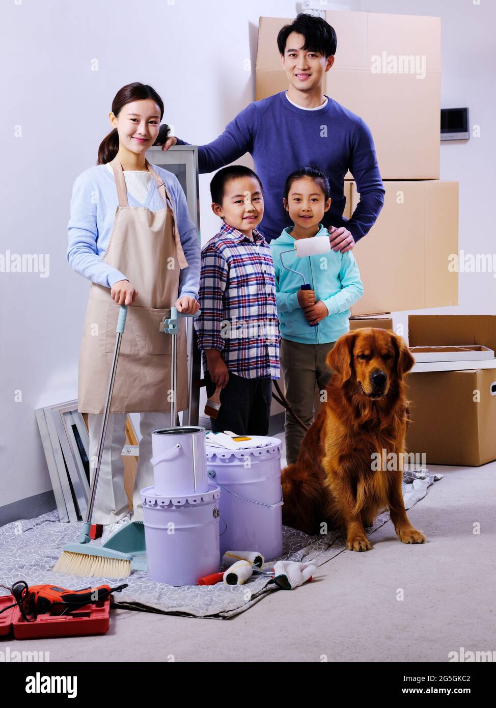 A happy family of four and a pet dog decorate the house high quality photo Stock Photo
