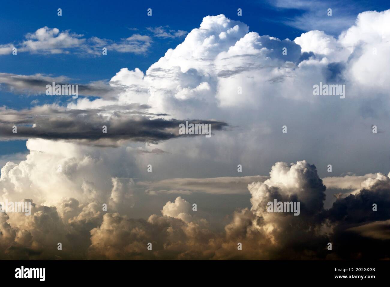 Changing weather. Storm clouds beginning to mix with white billowing cumulus clouds. New Jersey, USA Stock Photo
